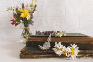 book, flowers and pocket watch