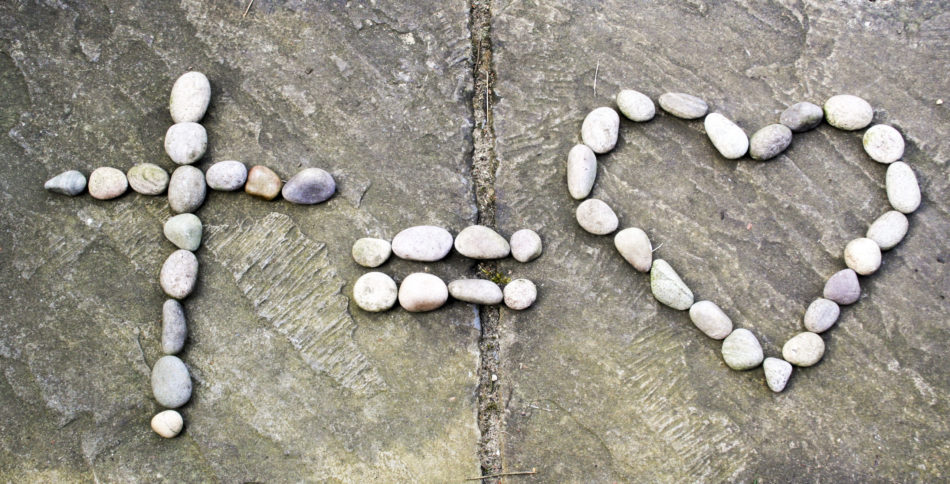 Cross equals love in stones