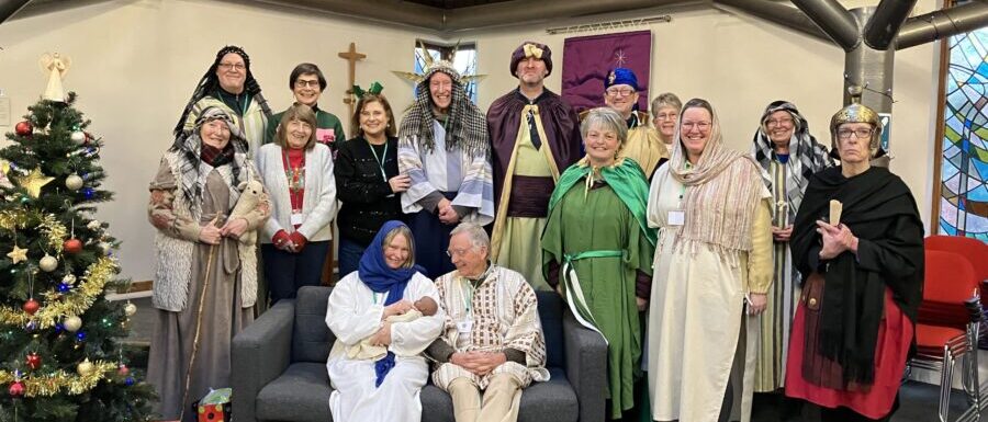 People dressed as Nativity characters gathered together