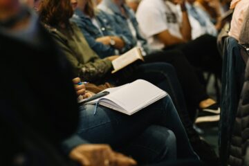 large meeting with people taking notes