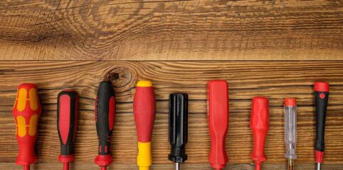screwdriver handles displayed on a wood board