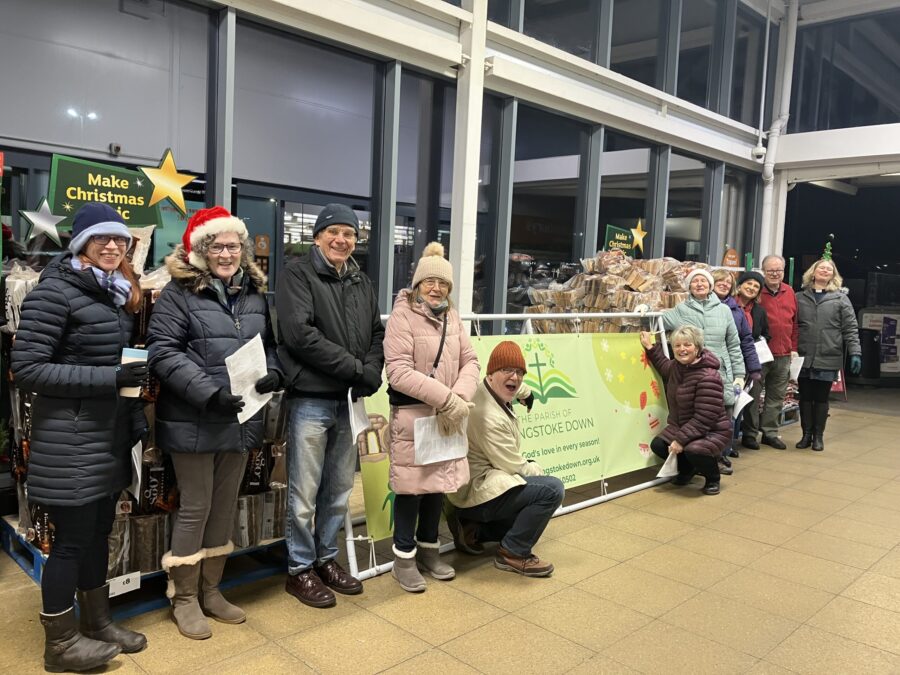 a group of POBD people singing outside Sainsbury's shop