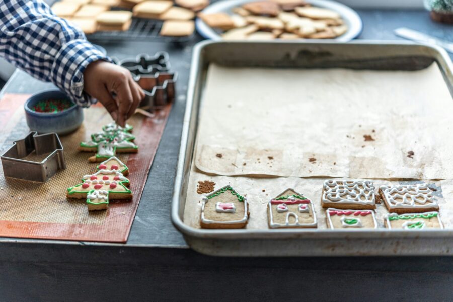 Child decorating gingerbread Christmas biscuits