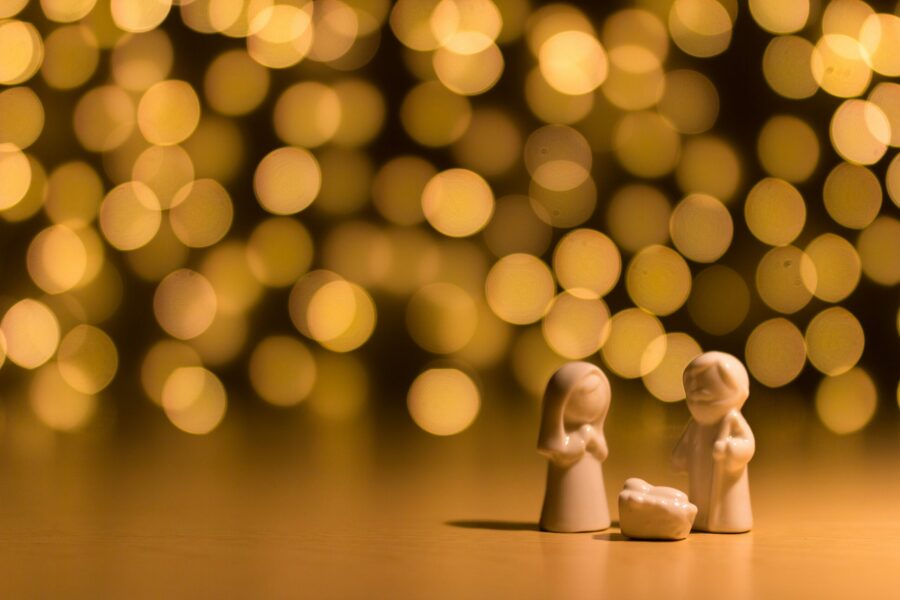 porcelain nativity figures against sparking gold background