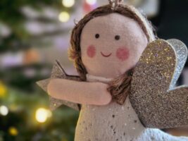 Christmas angel doll holding a silver star