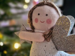 Christmas angel doll holding a silver star