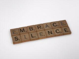 scrabble tiles that say 'embrace silence'