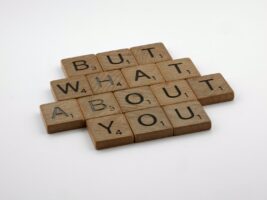 scrabble tiles spelling 'but what about you'