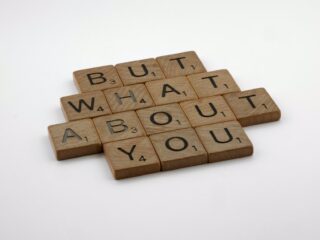 scrabble tiles spelling 'but what about you'