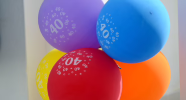 coloured 40 balloons tied to a post