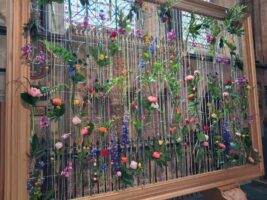 a strung pictures frame with flowers woven