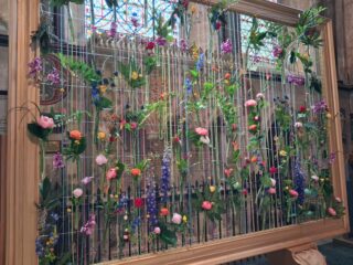 a strung pictures frame with flowers woven