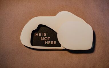 paper cutout of tomb with words 'he is not here'